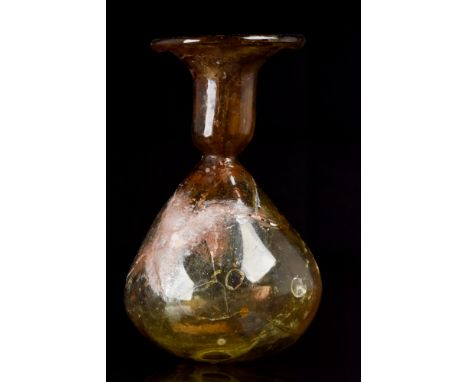 Ca. 200-300 AD. A beautiful deep amber-coloured glass flask with a wide mouth, folded rim, tapering neck leading to a tear-dr