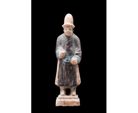 Ca. 1368-1644 AD or later . A glazed terracotta mingqi depicting a standing attendant on a tiered, integral base. He is portr