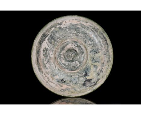 Ca. 50-200 AD. A beautiful light green, blown glass dish with a rounded lip on a low round foot. Strabo (Geography 16.2.25) t