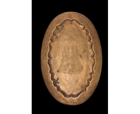 Deccan, ca. 16th-18th century AD. A brass oval-shaped tray with a beautifully shaped recess and flat rim. The sunken part of 