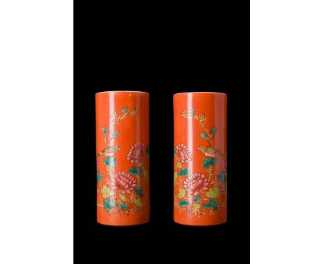 A pair of tall brush washers characterised by their tubular bodies, which sit atop circular bases, creating an elegant and ha