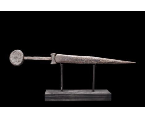 Ca. 1300-1500 AD. A medium-sized iron double-edged dagger with a sculptured cross guard in the shape of a hammer head and tap