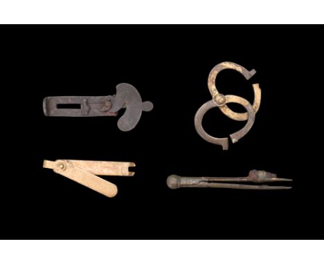 Ca. 1500-1600 AD. A group of measuring instruments, including a compass/divider and an assortment of other tools to aid in th