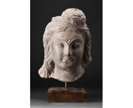 Ca. 200-300 AD. A schist head of a Bodhisattva, a stunning masterpiece of art that embodies the profound spiritual insights o