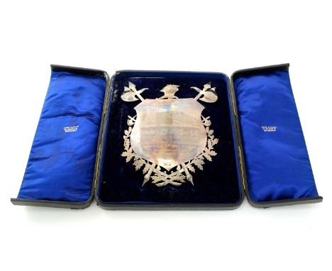 A late Victorian silver presentation shield, engraved with a view of an architectural landscape, with the” old style” industr