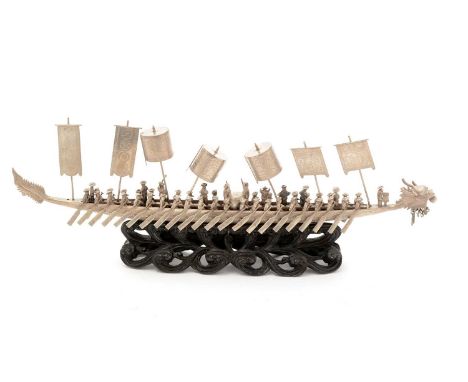 An early 20th Century Chinese silver miniature dragon boat, with a myriad of oarsmen and lift-off canopies and banners, maker