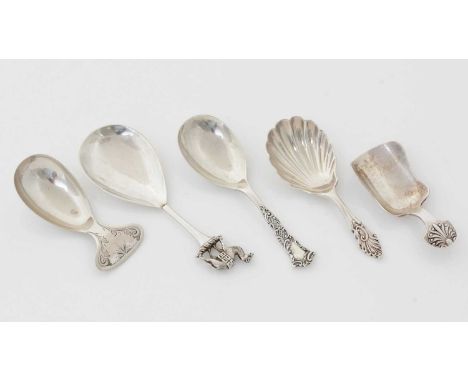 A late Victorian silver caddy spoon, with a cast finial in the form of the crest of the Worshipful Company of Grocers (a spic