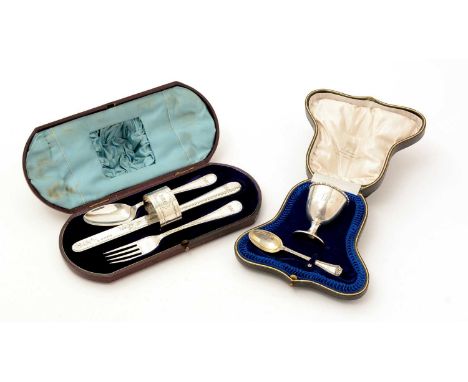 Two boxed sets of silver: a George V egg cup and spoon, both initialled and the egg cup dated "15.12.19", by J. Williams &amp