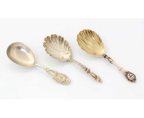 Two Victorian silver caddy spoons, with mask terminals; and another with a figural terminal, by various makers, London 1869-1