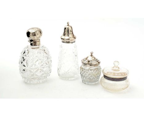 Four silver mounted cut-glass pieces: a late Victorian toilet water bottle, with a plain globular hinged cover and glass stop