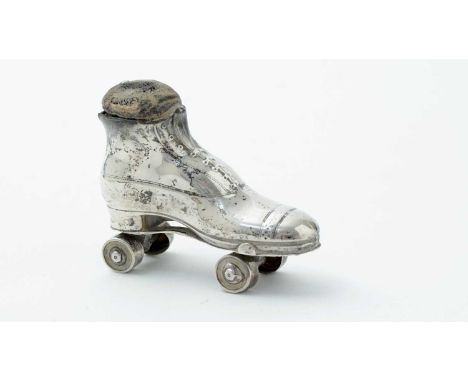 An Edwardian silver novelty pincushion, in the form of a roller skate boot, by Sydney and Co, Birmingham 1909, 7cm long.