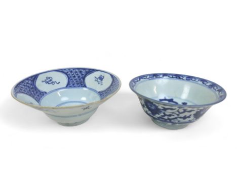 Two Chinese blue and white porcelain bowls, one with flared rim and four oval reserves on a cell ground, raised on a circular