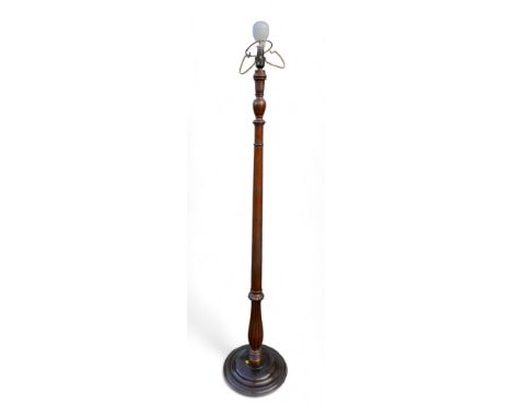 A mahogany standard lamp, part reeded, turned column on circular base. 