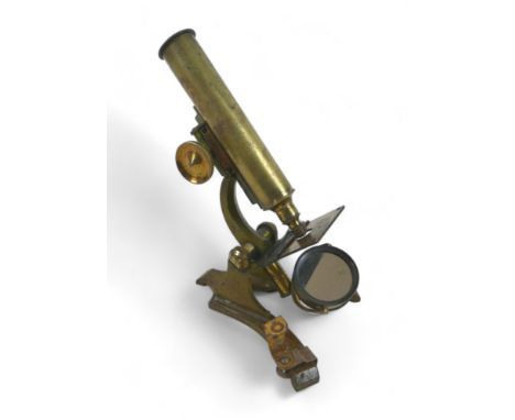 A mid 20th century university brass microscope, circa 1940, 21cm high, with light, and in a mahogany case, 21 by 24 by 22cm h