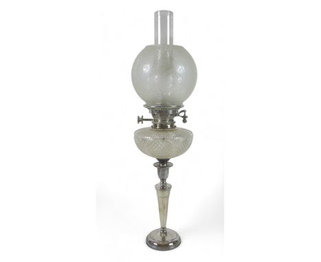 A silver plated oil lamp, with cut glass font and etched shade, 16 by 65cm high. 