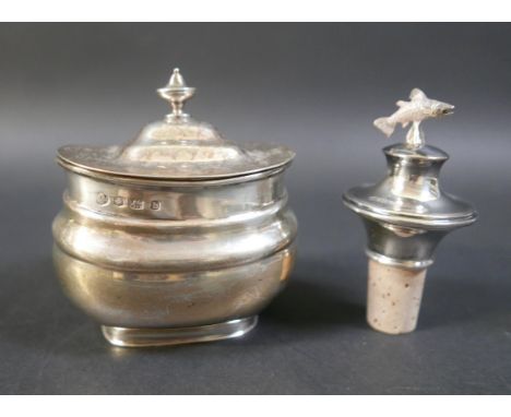 A George V silver tea caddy, Sheffield 1925/26, and a silver spirit stopper with salmon finial, caddy measures 9 by 8 by 10cm