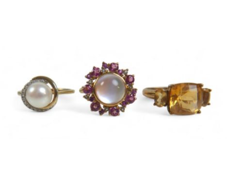 A group of three 9ct gold ladies dress rings, comprising a three stone citrine ring, the central, cushion cut stone measuring