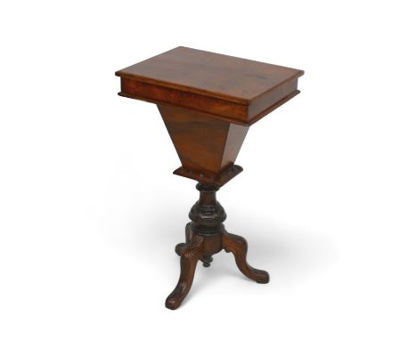A Victorian walnut workbox on a tripod base, with a fitted interior and writing flap, 47 by 35 by 77.5cm tall. 