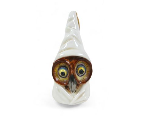 A Royal Worcester candle snuffer in the form of an owl, with yellow eyes and tall nightcap with gilt tassel, burgundy mark, 8