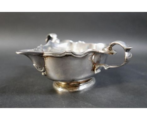 A Britannia standard silver double handle sauce boat, date letter k, maker G P. 428 gs/13.7 troy oz, 18 by 20 by 8cm high. 
