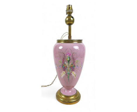 An early 20th century china table lamp, of vase form decorated with a floral spray against a pink ground, brass fittings with