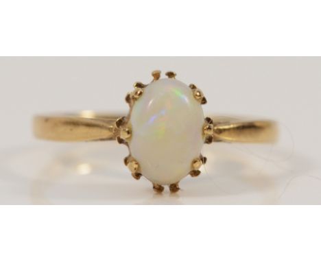A 9ct gold opal solitaire ring, 7mm x 4mm opal, K, 1.1g
