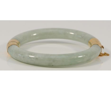 A 14k gold jade bangle, 58mm internal diameter, 48.2g