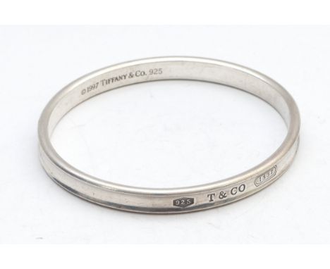 Tiffany &amp; Co., a silver concave bangle, dated 1997, 65 x 58mm, 35gm