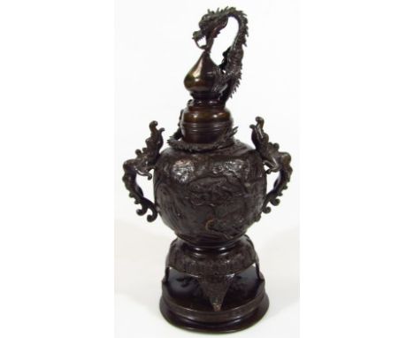 An elaborate Chinese bronze incense jar and cover, of shaped outline with heavy part pierced dragon handles and knop, repouss