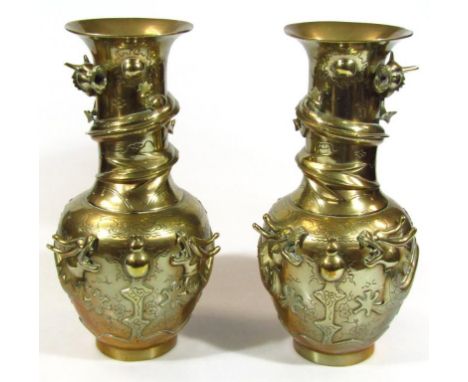 A pair of late Qing period Chinese polished bronze vases, each with trumpet stems and bulbous bodies, raised with entwined dr