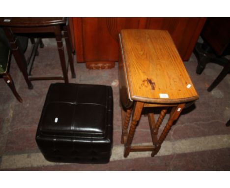 AN OAK DROPLEAF TABLE TOGETHER WITH A LEATHER POUFFE