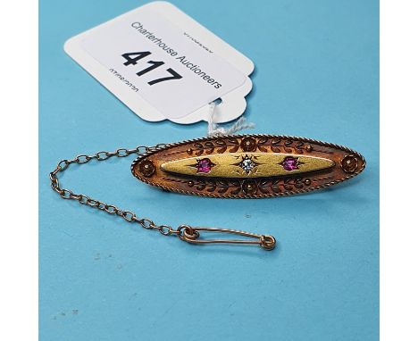 A 15ct gold, ruby and diamond brooch, of navette form 
