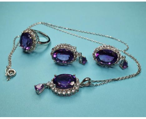 A silver and amethyst ring, a matching pendant and earrings 