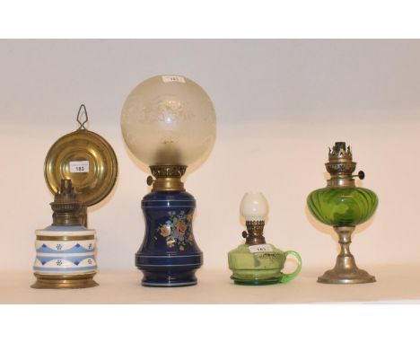 A late 19th/early 20th century spelter oil lamp, with green glass well, and nine others (10)A brass an blue and white oil lam