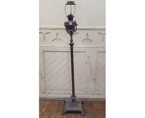 A late Victorian brass floor standing lamp, with a corinthian column 