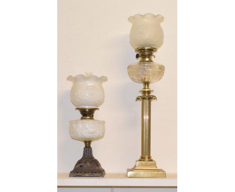 A 19th century gilt metal oil lamp, in the form of a column with clear glass well, 80 cm high, and another (2) 