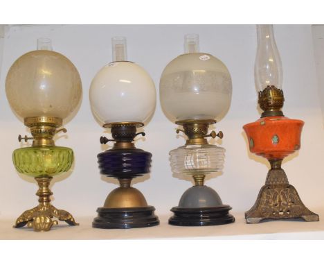 A late 19th/early 20th century spelter oil lamp, with blue glass well, and six others (7) 