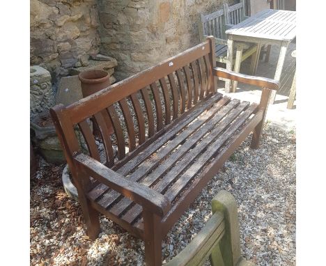 A teak garden bench, another, and a garden bench with cast metal ends, with lion head handles (3) 