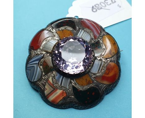 A Scottish pale amethyst and agate target type brooch, in a silver coloured metal setting with engraved decoration, 5.5 cm di
