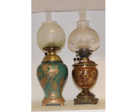 A late 19th/early 20th century Continental porcelain oil lamp, with gilt metal mounts, cut glass shade, 62 cm, and another (2