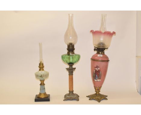 A late 19th/early 20th century porcelain oil lamp, pink ground painted with female figure, and five others (6) 