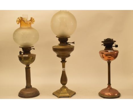 A late 19th/early 20th century brass oil lamp, with engraved glass shade, and five others (6) 