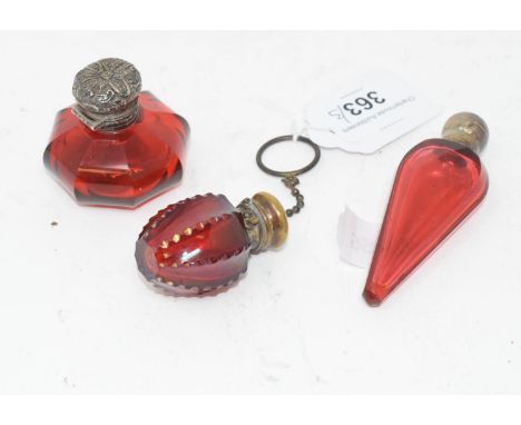 A Victorian ruby glass scent bottle, of compressed octagonal form, and two other similar scent bottles (3)some scratches to t