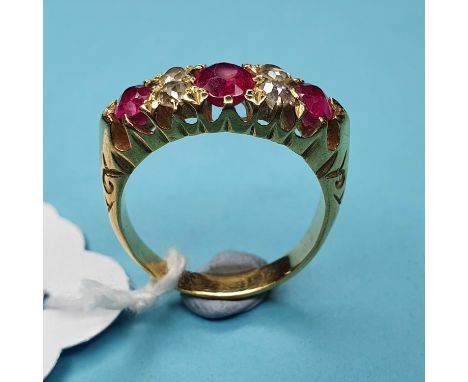 A yellow coloured metal, diamond and ruby ring, having three rubies interspersed by four diamonds, marks rubbed, probably 18c