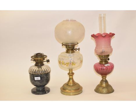 A brass oil lamp, with clear glass shade, and five others (6)Rough areas to touch on base of shade, shallow chips to base no 