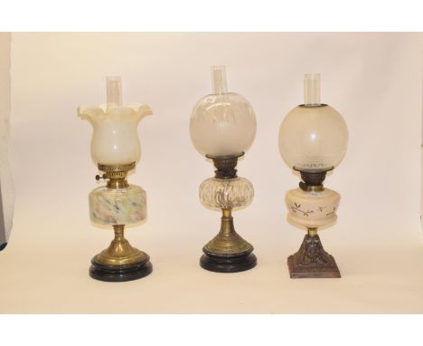 A late 19th/early 20th century brass oil lamp, with engraved glass shade, and five others (6) 