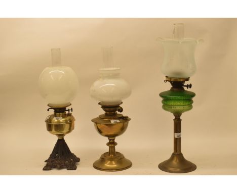 A late 19th/early 20th century brass oil lamp, and five others (6)Green font with hairline crack,   other wells no major faul