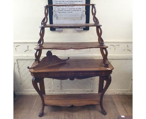 A 19th century Continental walnut bookcase/shelf unit, having three graduated tiers on a base with a plain frieze with cabrio