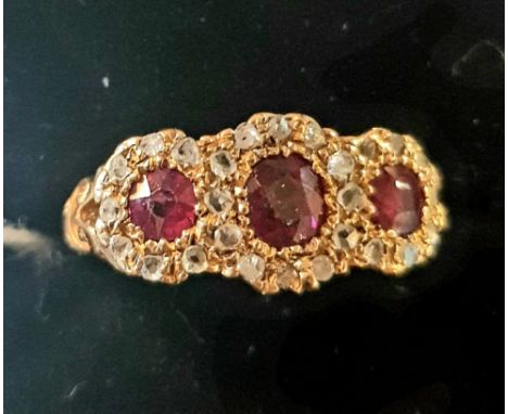 An 18ct gold, ruby and diamond triple flowerhead ring, approx. ring size N 