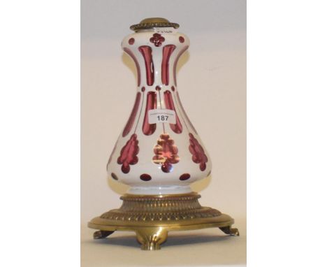 A 19th century cased red and white glass oil lamp base, with gilt metal mounts, raised on lion paw feet, 30 cm highPossible h
